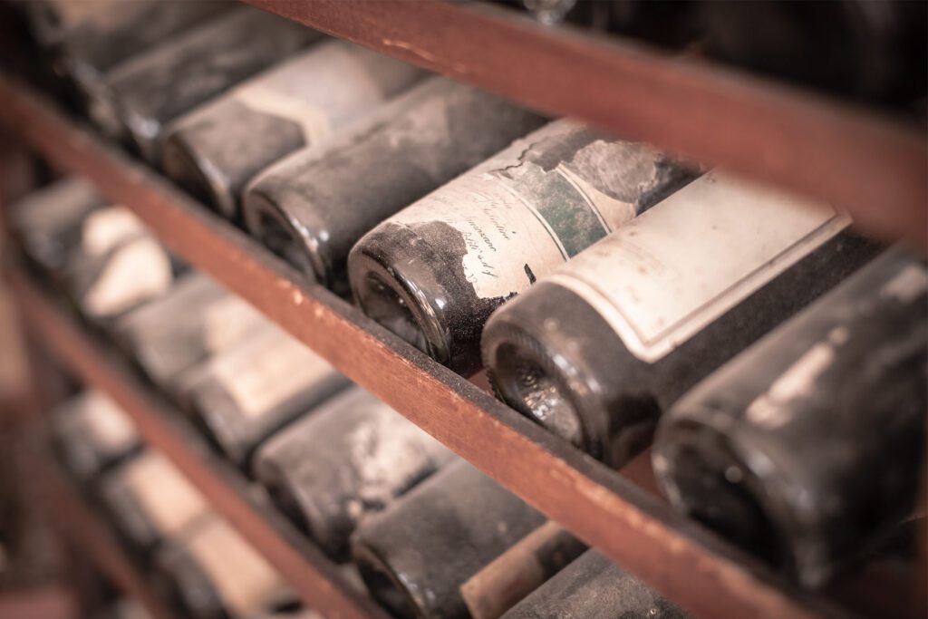 Dusty wine bottles on a wine rack