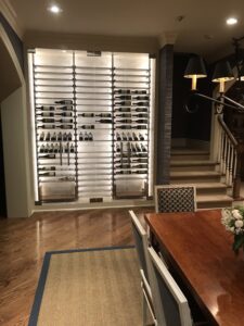 LED backlit glass wine wall in a dining room